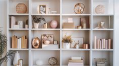 a white book shelf filled with lots of different types of books and vases on top of it