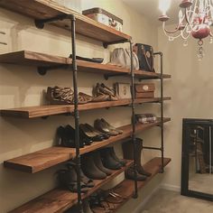 the shelves are filled with shoes and purses