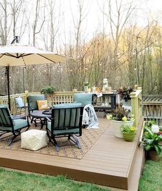 a deck with chairs and an umbrella on it