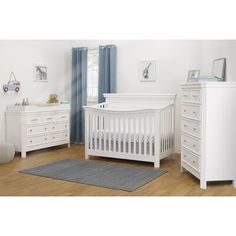 a baby's room with white furniture and wooden floors