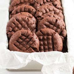 chocolate cookies in a white box on a table