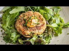 a close up of a plate of food with lettuce and meat patties