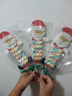 someone is holding candy canes wrapped in plastic