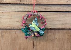 a colorful bird decoration hanging from a wooden door