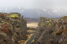 a narrow road cuts through the rocky terrain