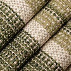 three pieces of woven fabric with green and white squares