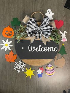 a welcome sign surrounded by paper cutouts and decorations