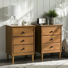 two wooden dressers sitting next to each other on top of a carpeted floor