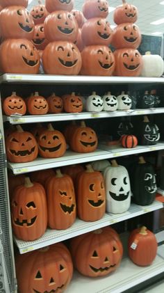 pumpkins and jack - o'- lanterns are on display in a store