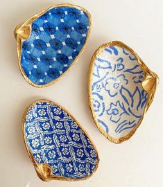 three blue and white dishes sitting on top of a table