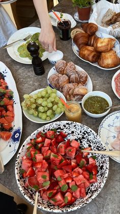 a table topped with plates and bowls filled with food