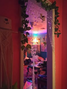 a room with a mirror, plants and lights on the wall in it's doorway