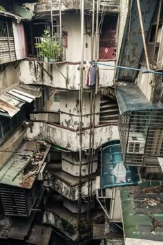 an old run down building with lots of windows and balconies on the roof