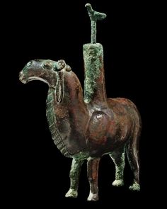 a bronze statue of a horse with a saddle on it's back and neck