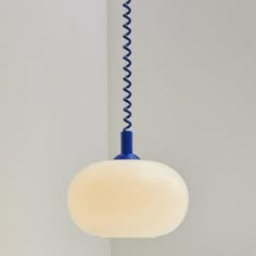 a blue and white light hanging from a ceiling