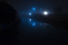 foggy night with street lights reflecting in the water