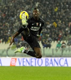 a soccer player in mid air after kicking the ball