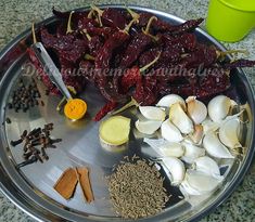 an assortment of spices and herbs on a metal plate