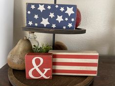 an american flag and amp sign are on a wooden stand next to some other items