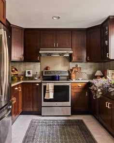 a kitchen with wooden cabinets and stainless steel appliances