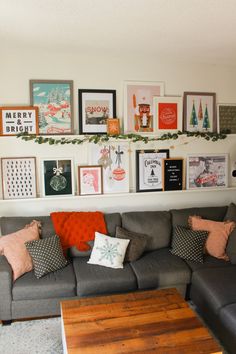 a living room filled with lots of furniture and pictures on the wall above it's coffee table