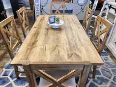 a wooden table sitting on top of a blue and white rug