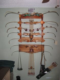 a wall mounted archery rack with many arrows