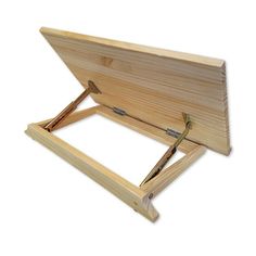 a wooden easel sitting on top of a white surface