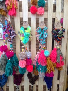 many different colored tassels hanging on a wall