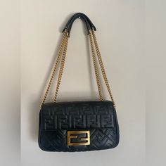 Women’s Black Baguette Bag Black Lamb Leather With Gold Chain/Hardware And Trendy Fendi Design Can Be Worn As A Cross Body Or Shoulder Bag Purchased In France For 2600 Euros (2850$ Usd) On June 6, 2022 Comes With Dust Bag And Original Receipt (I Will Need To Cut The Receipt A Bit Because It Has Personal Information On It) This Bag Has Been Used And Has Some Wear/Tear On The Hardwarebottom Corners Also Have Some Wear (See Pics) Still In Great Condition I Haven’t Seen This Bag Being Sold Anywhere In The U.S Accepting Reasonable Offers Selling “As Is” Black Baguette Bag, Fendi Bag, Baguette Bag, Fendi Bags, Gold Chain, Cross Body, Dust Bag, Fendi, Bag Lady