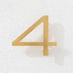 the number four is shown on a white wall