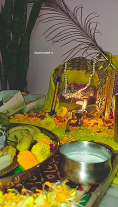 an assortment of food on a table with candles and flowers in the middle, surrounded by other items