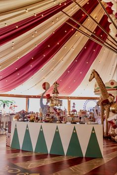 an elaborately decorated tent with giraffes and other items on it's table