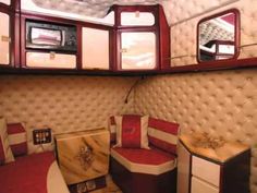 the inside of a train car with red and white furniture