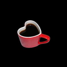 a red cup filled with coffee on top of a black table