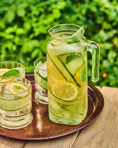 a pitcher and two glasses filled with lemonade