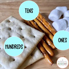 some kind of cracker and marshmallows on a wooden table with labels