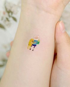 a person with a small tattoo on their wrist