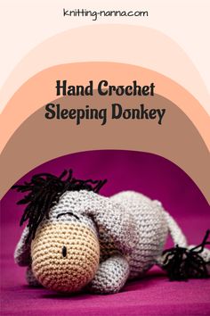 a crocheted stuffed animal laying down with the words hand crochet sleeping donkey