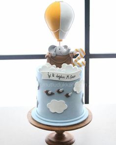 a birthday cake with an air balloon on top