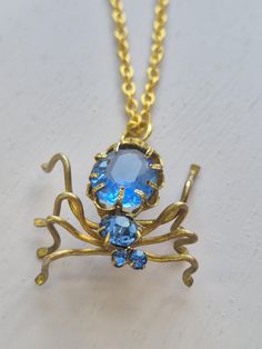 Step back into the art deco era with this stunning vintage czech glass spider necklace c 1945. A true collectible statement piece. The pendant was actually a broken brooch missing its pin with some of the glass loose so i hand drilled the hinge to create a bail and cleaned everything up before adding a new 18 inch gold plated chain. The cornflower blue stone is back looking beautiful in full art deco 1930s-1940s glamour and i'm glad this beauty can be worn again. Spiders are often symbols of cea 1940s Glamour, Glass Spider, Glamour Art, Spider Necklace, Cornflower Blue, Antique Jewellery, Gold Plated Chains, Vintage Art Deco, Blue Stone