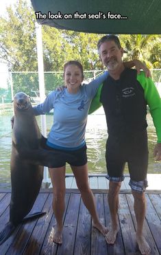 the man and woman are posing with an animal