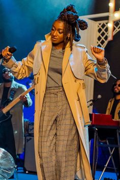 a woman with dreadlocks standing on stage