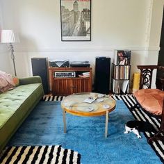 a living room filled with furniture and a blue rug