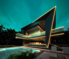 a house that is lit up at night with the lights on and swimming pool in front