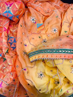 an orange and yellow sari with beads on it