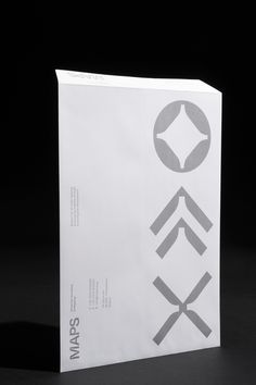 a white paper bag sitting on top of a black table next to a pair of scissors