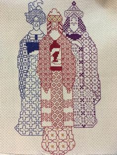 the cross stitch pattern shows three women in different outfits, one with a number on her chest