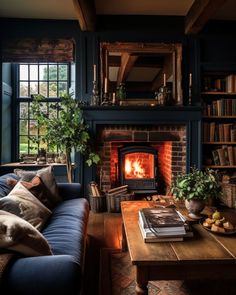 a living room filled with furniture and a fire place next to a book shelf full of books