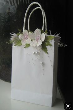 a white paper bag with flowers on it